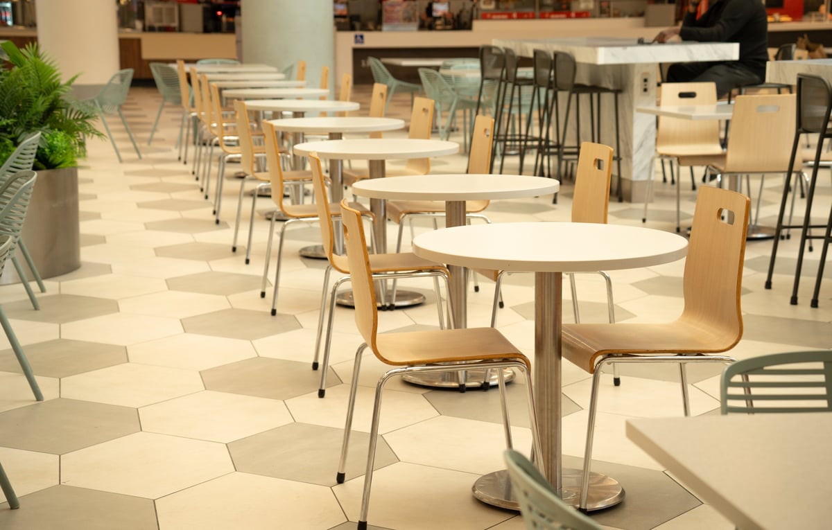 Contemporary dining space at Eyaleq'ep Food Court with light wood chairs and modern design